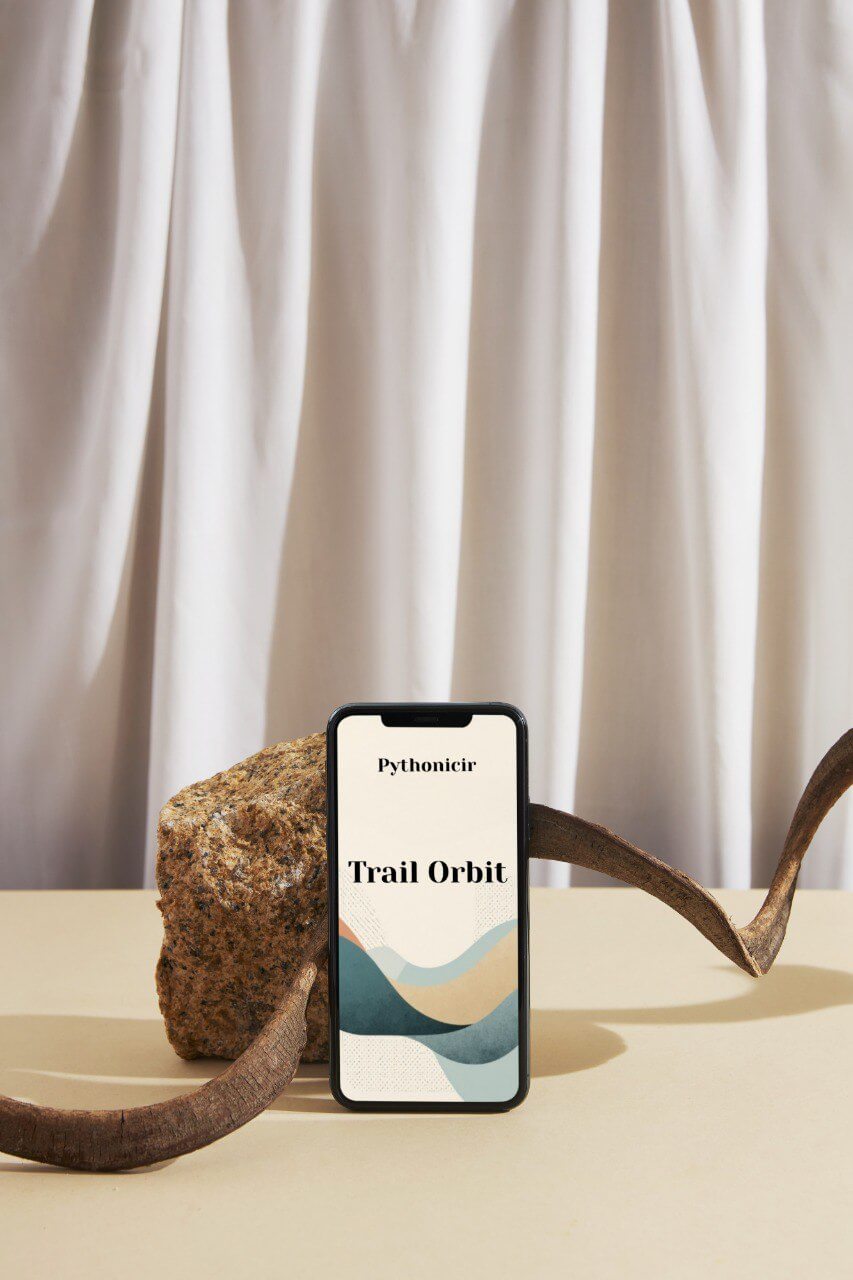 Phone displaying 'Pythonicir Trail Orbit' course with natural background